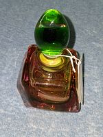 Murano bottle top view showing green stopper and hang tag