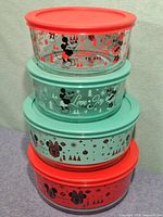 All four bowls stacked displaying design and lid colors