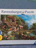 Front of Ravensburger puzzle box showing cottage landscape image and 300-piece count