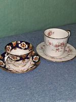 Two complete teacup & saucer sets side by side