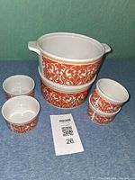 Front view showing casserole dish with handles and six ramekins