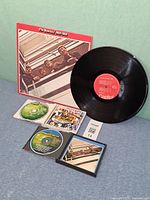 Front cover of 1962-1966 jacket, one vinyl disc, three Anthology CDs and booklet displayed