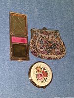 Open rectangular compact, closed round compact, closed tapestry coin purse