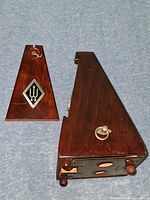 Metronome body and separate lid showing interior and base wear