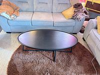 Top-down view showing entire oval table, finish, and shape