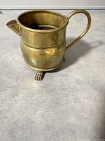 Front angle showing full pitcher, claw foot visible