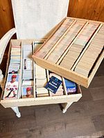 Two long storage boxes filled with baseball cards and sealed card sleeve pack