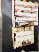 Stacked cardboard sorting boxes filled with rows of baseball cards