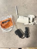 Camera, antenna, Ethernet cable, power adapter on countertop