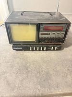 Front view showing CRT screen, LED clock display and control panel