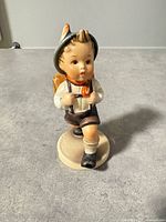 Front view of Hummel schoolboy figurine on base