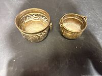 Top view of both brass pots showing interiors, patina and pierced design