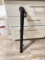 Retractable gate rolled in cylindrical housing standing upright