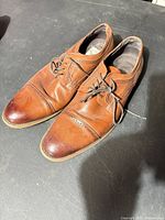 Pair of Stacy Adams brown cap-toe oxford shoes showing overall condition