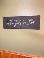 Full view of wooden wall plaque hanging on wall