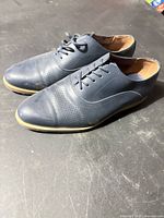 Side and front view of both shoes showing uppers and laces