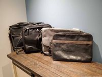 Overall view of four laptop and messenger bags on table