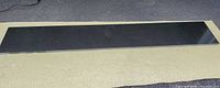 full view of polished black granite slab on ground