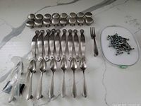 All hardware pieces laid out: knobs, pulls, utensil pulls, screws
