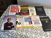 Front covers of all nine books laid out on patterned surface