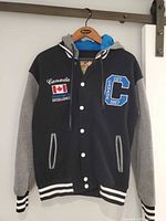 Front view showing colours, snap closure, front patches, pockets