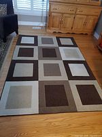 Full view of rug showing entire geometric design and colors