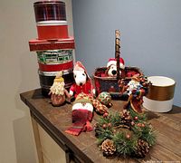 Overall lot showing cookie tins, figurines, basket, wreath, planter