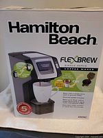 Front of retail box showing Hamilton Beach FlexBrew coffee maker image and specifications