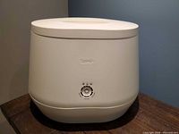 Front and top view of Lomi composter showing control panel and lid