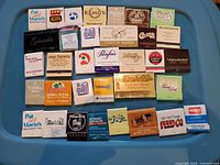 overview of all matchbooks laid out on blue surface