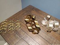 All napkin rings grouped on tabletop showing three finish groups
