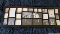 Front view of black collage picture frame showing all 24 openings
