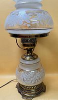 Full view of assembled lamp showing brass base and two-piece frosted glass shade