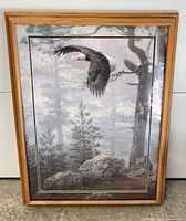 Front view of framed eagle print in oak frame
