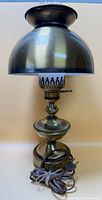 Lamp assembled showing brass-tone dome shade and cord