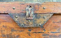 close-up of front lock hardware on wooden chest