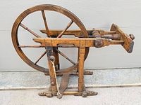 Side view showing full spinning wheel, drive wheel, frame and flyer area