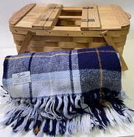 Basket and blanket together, shows overall appearance, colors, tag on blanket partly visible
