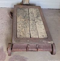 Full view of wood plank platform framed by cast iron with Buffalo Scale Co. inscription