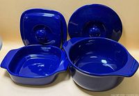 Front view showing both casserole dishes with lids upright