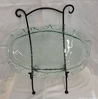 Platter on metal stand, front view showing bubble texture and ruffled edge