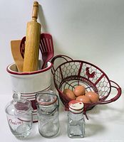 Group shot of crock with utensils, egg basket, glass jars