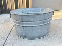 Front view of galvanized steel tub showing ribbed banding and handle