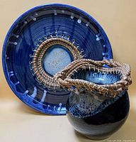 Platter standing behind vase showing overall glaze color and woven trim