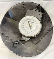 Front view showing dial face marked Hanson Model 8200, 200 lb capacity, chains and pan