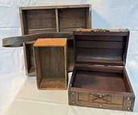 Three wooden boxes shown open and closed with leather strap visible