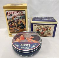 Front view of all three tins showing artwork and shapes