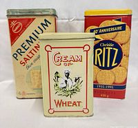 Front view of all three branded tins