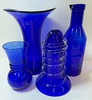 Group shot showing all four cobalt blue glass items