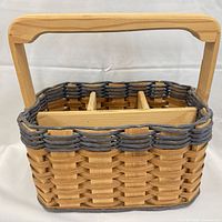 Front view of woven basket with handle and blue trim